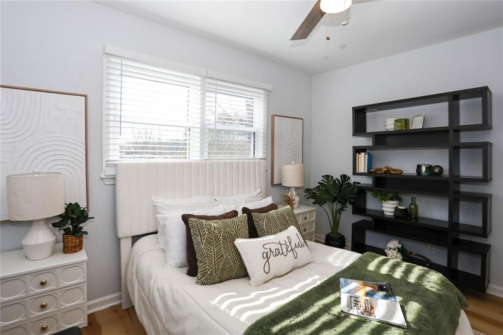 1745 Rockbridge Road Northwest Conyers, GA 30012 - Photo 30 of 46 a bedroom with furniture and a potted plant