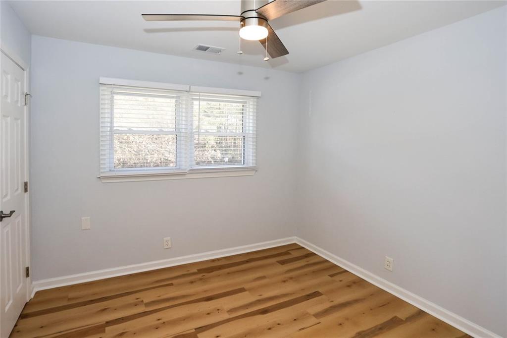 1745 Rockbridge Road Northwest Conyers, GA 30012 - Photo 36 of 46 wooden floor in an empty room with a window
