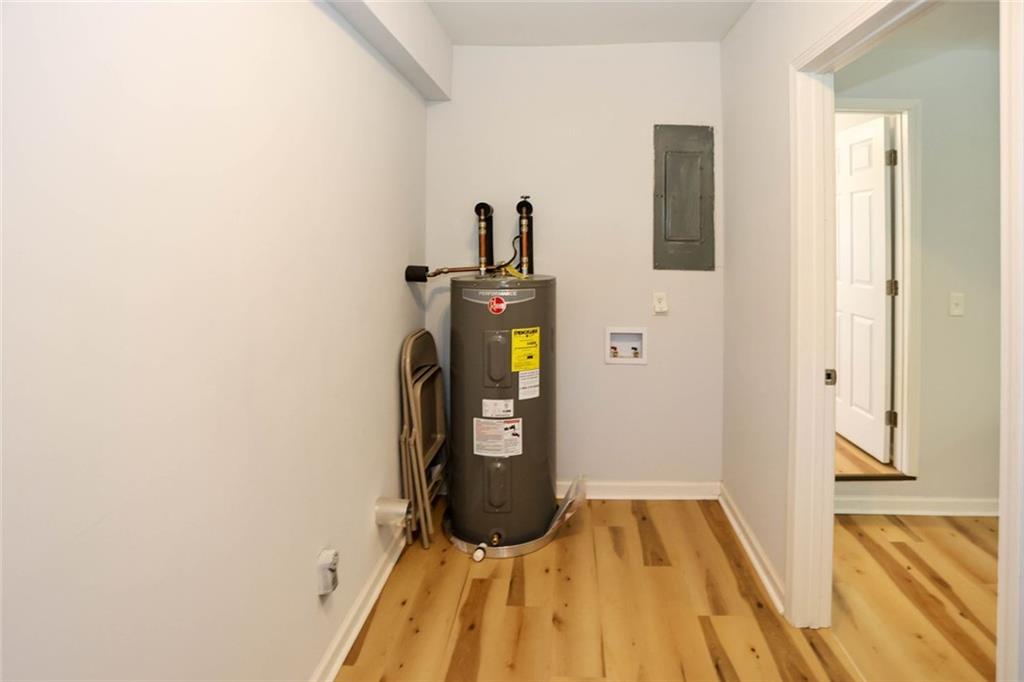 1745 Rockbridge Road Northwest Conyers, GA 30012 - Photo 38 of 46 a view of a hallway with wooden floor and staircase