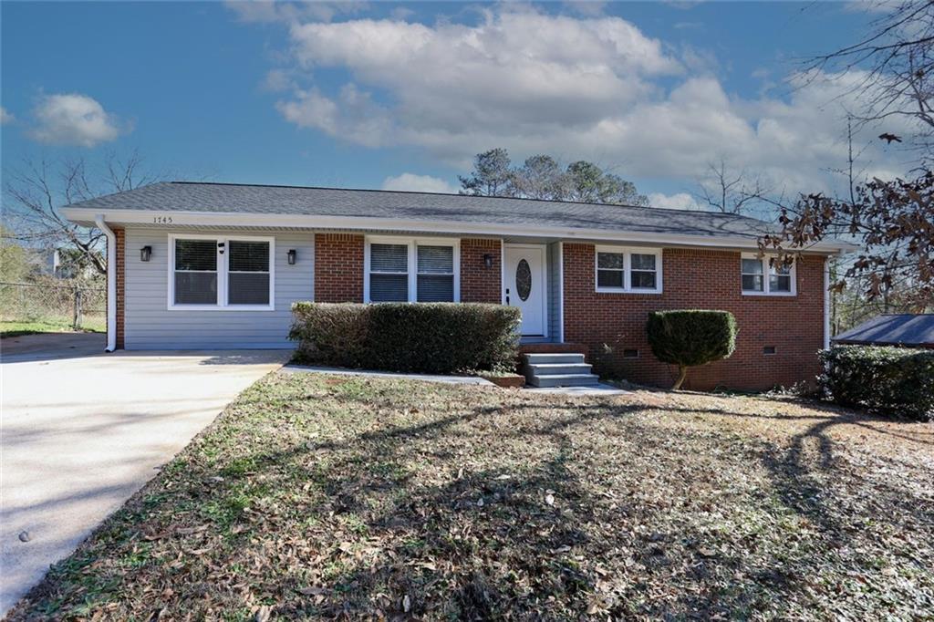 1745 Rockbridge Road Northwest Conyers, GA 30012 - Photo 45 of 46 a front view of a house with a yard and potted plants