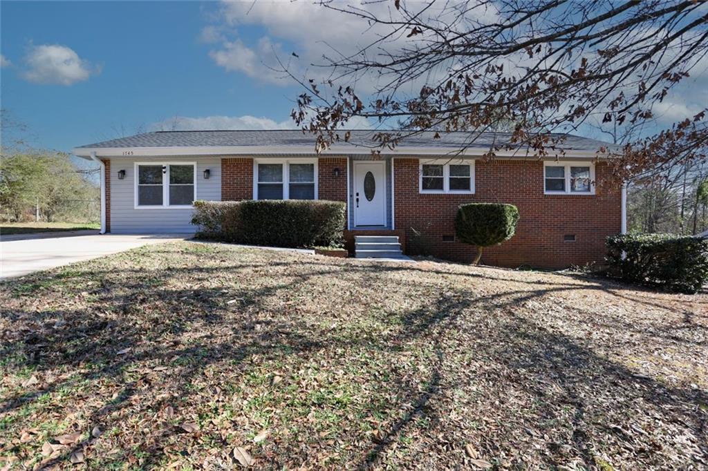 1745 Rockbridge Road Northwest Conyers, GA 30012 - Photo 46 of 46 a front view of a house with a yard