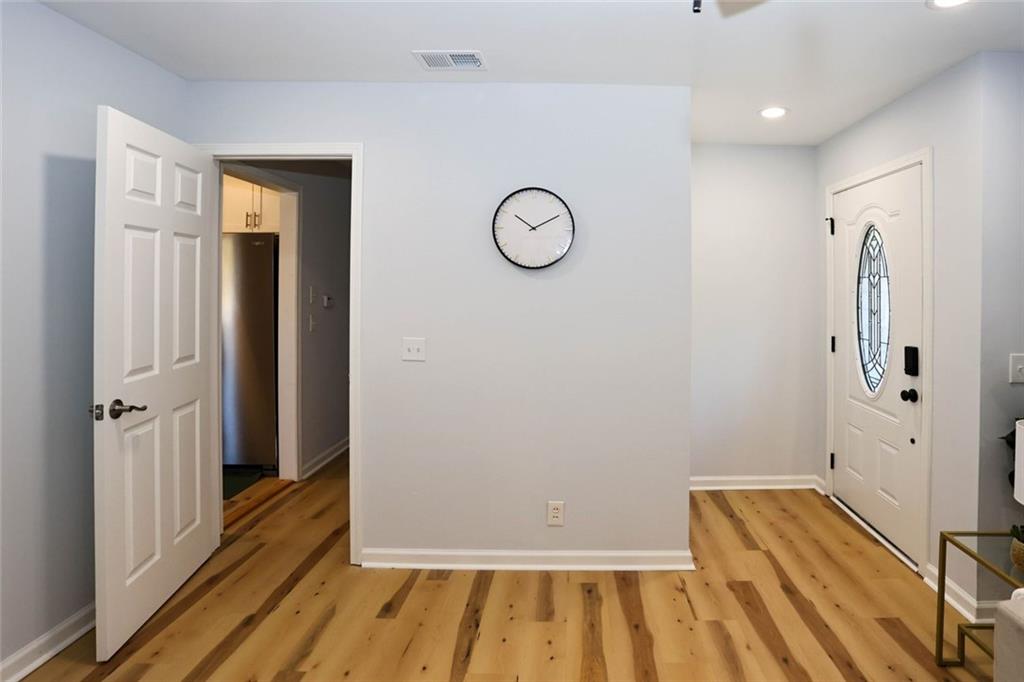 1745 Rockbridge Road Northwest Conyers, GA 30012 - Photo 6 of 46 a view of a room with wooden floor and white walls