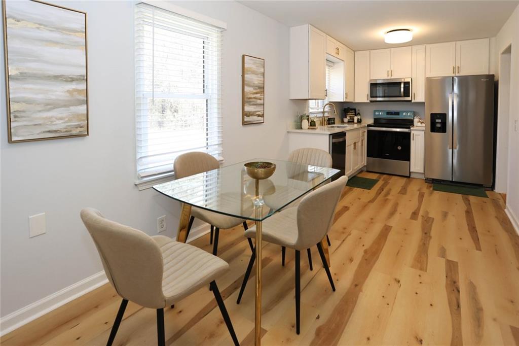 1745 Rockbridge Road Northwest Conyers, GA 30012 - Photo 7 of 46 a view of a dining room with furniture and a window