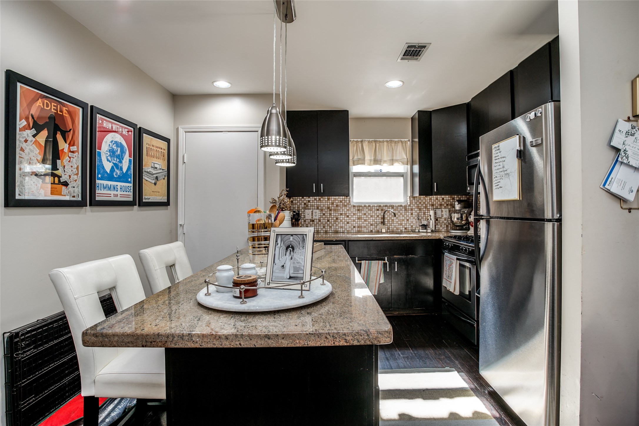 910 West 9th Street Houston, TX 77007 - Photo 7 of 20 a kitchen with stainless steel appliances kitchen island granite countertop a dining table and chairs