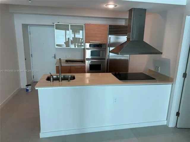 a kitchen with a stove and a refrigerator