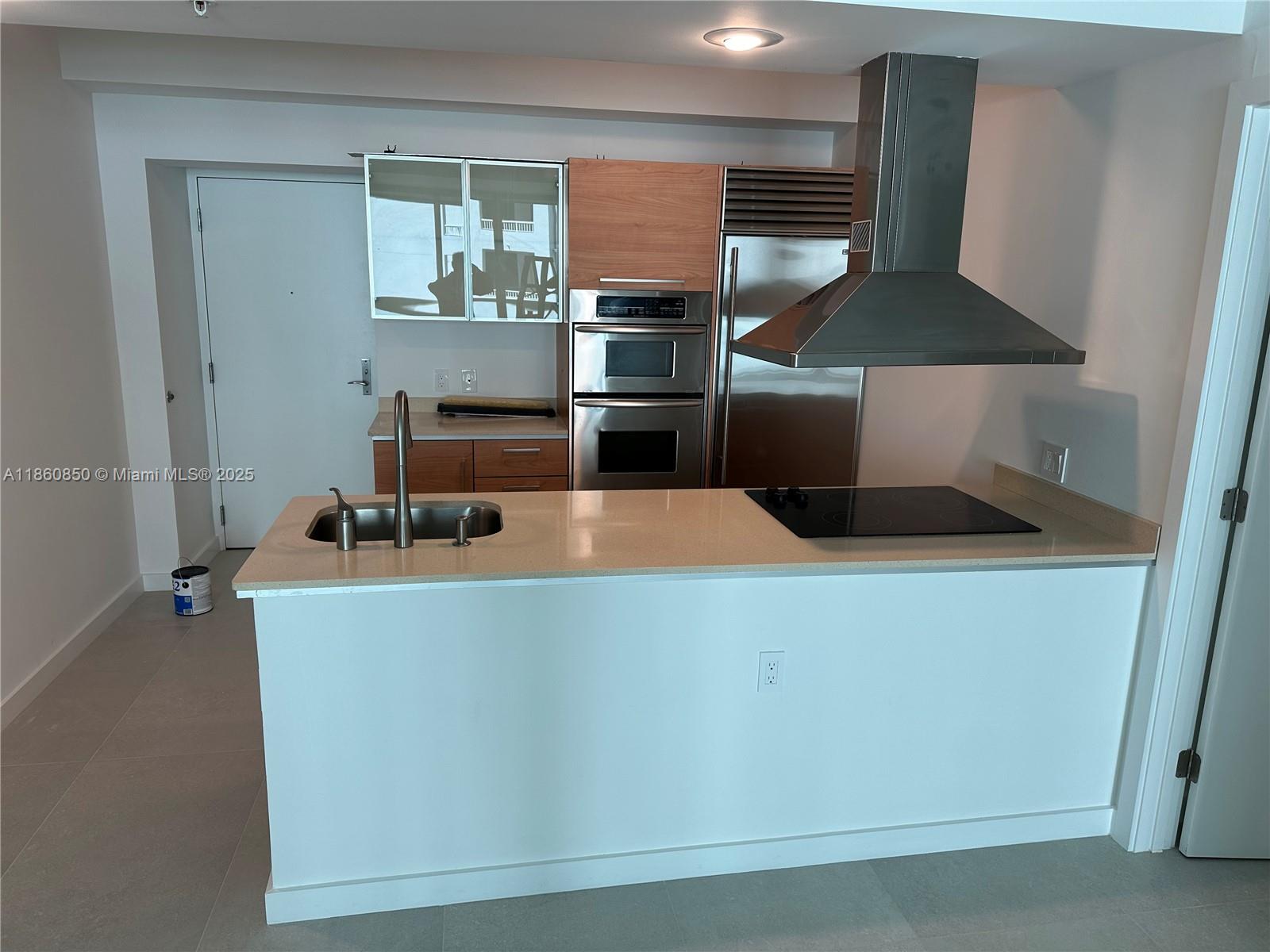 218 Southeast 14th Street, Unit 1508 Miami, FL 33131 - Photo 1 of 12 a kitchen with a stove and a refrigerator