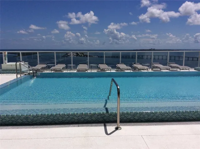 a swimming pool with outdoor seating and yard