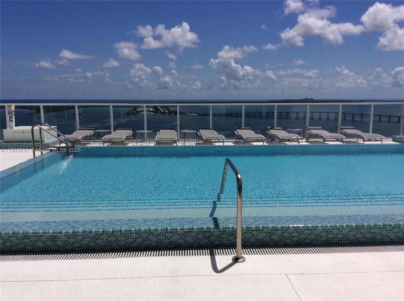 218 Southeast 14th Street, Unit 1508 Miami, FL 33131 - Photo 11 of 12 a room with a table and chairs