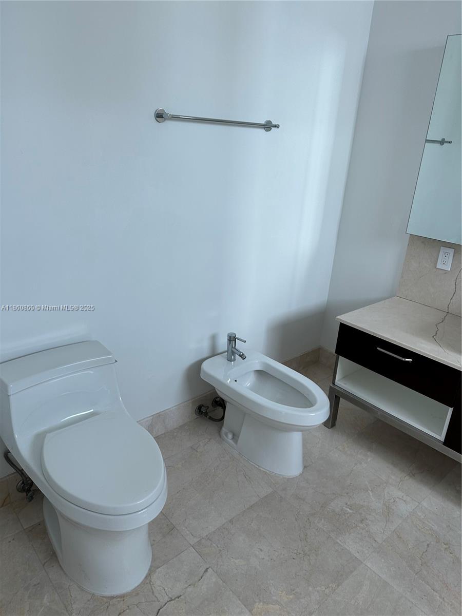 218 Southeast 14th Street, Unit 1508 Miami, FL 33131 - Photo 5 of 12 a white toilet sitting next to a white sink