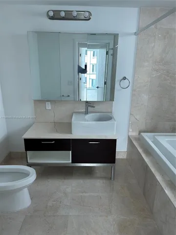 a bathroom with a bathtub sink and toilet