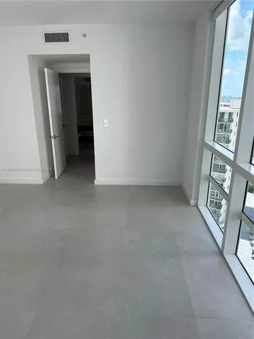 a view of balcony with wooden floor and seating space