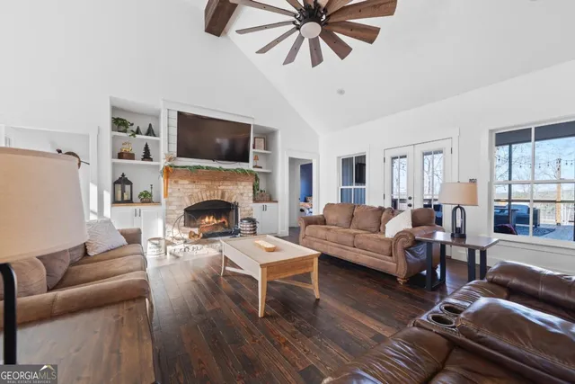 a bedroom with a bed and a flat tv screen on dresser