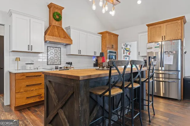 a bathroom with a toilet sink vanity and mirror