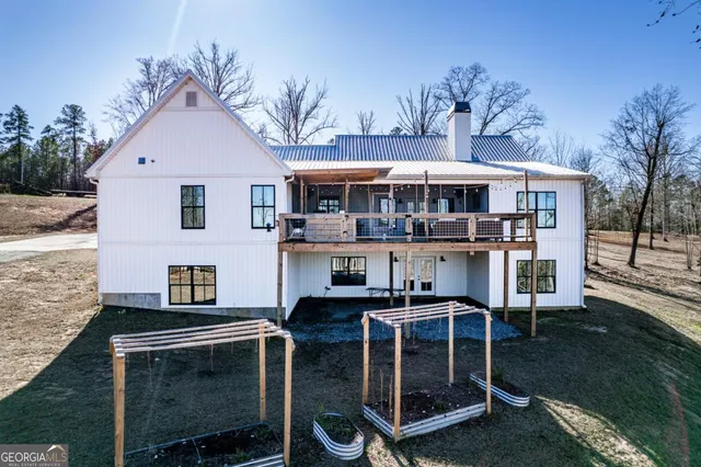 a view of a house with a yard balcony and furniture