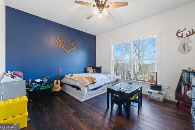 a kitchen with stainless steel appliances granite countertop a table chairs sink and cabinets