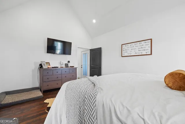 a view of living room with wooden floor and iron stairs