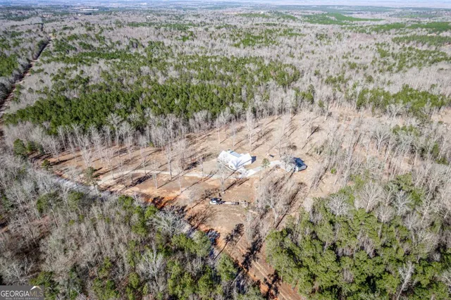 a view of a house with a yard covered in snow