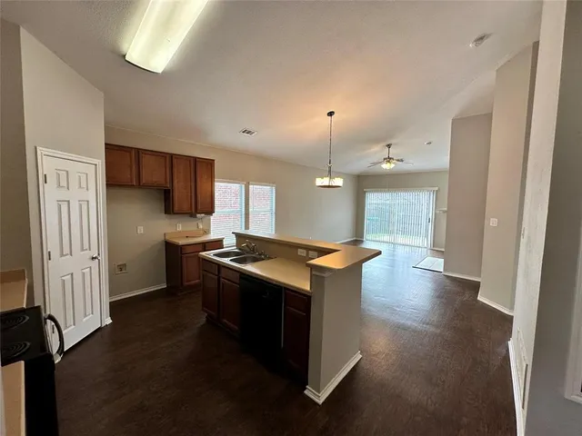 a kitchen with stainless steel appliances granite countertop a stove and a refrigerator