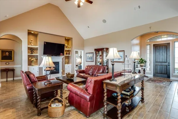 a living room with furniture a flat screen tv and a fireplace