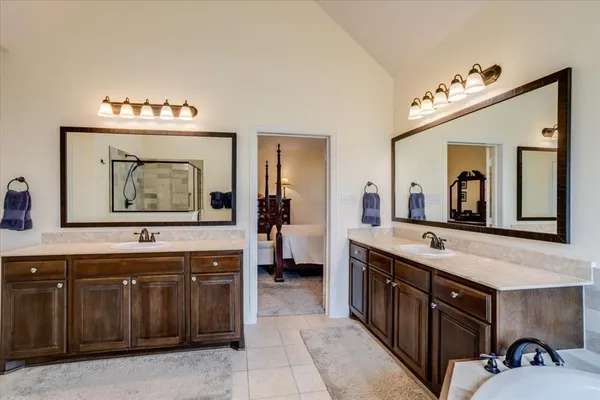 a spacious bathroom with a sink double vanity and a mirror