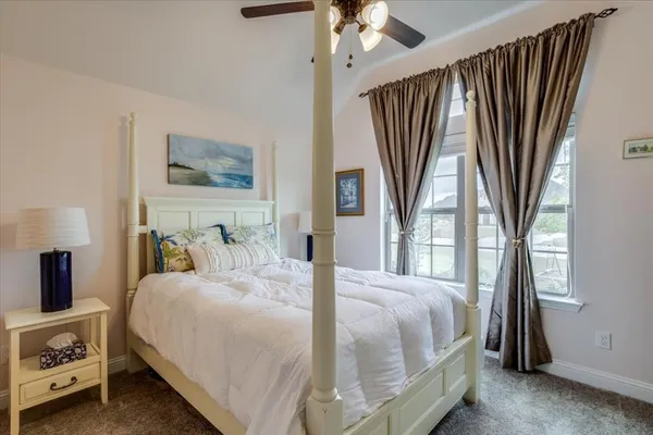 a bedroom with a large bed and a tv