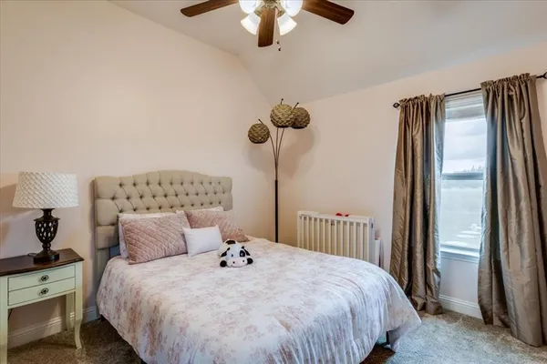 a bedroom with bed and a chandelier