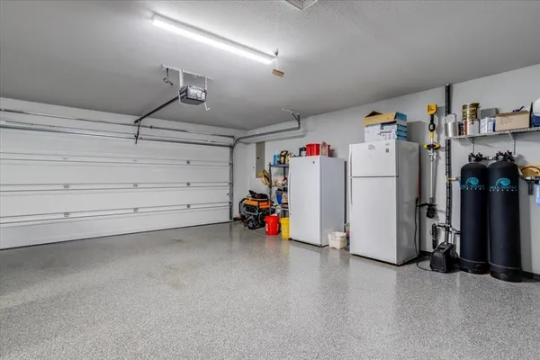 a view of storage and utility room with closet and windows