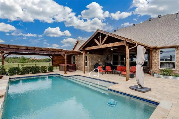 a view of a swimming pool and lounge chairs
