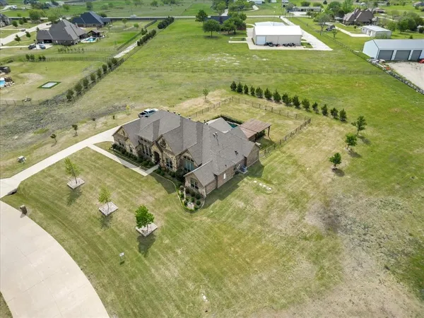 a view of a pool with lawn chairs and couches