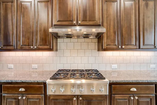 a stove top oven sitting inside of a kitchen