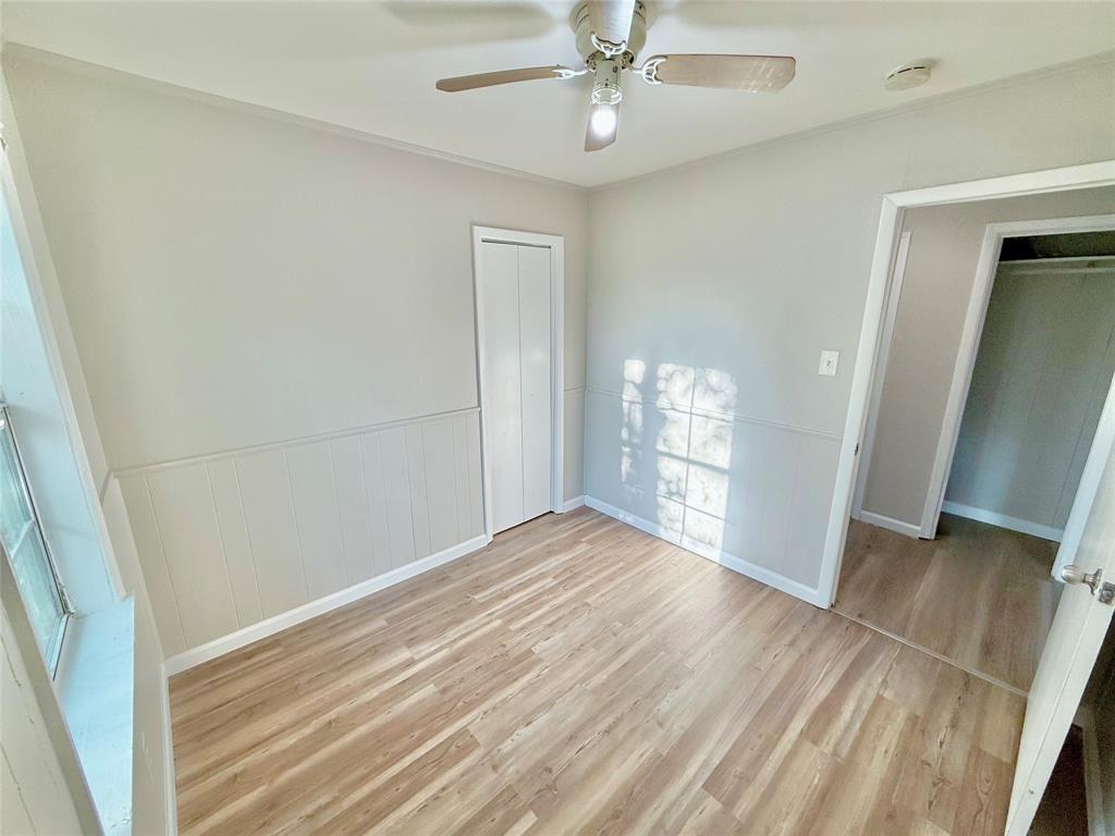 428 East Elm Street Denison, TX 75021 - Photo 12 of 18 wooden floor in an empty room with a window
