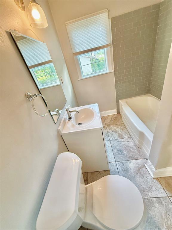 428 East Elm Street Denison, TX 75021 - Photo 14 of 18 a bathroom with a sink and toilet