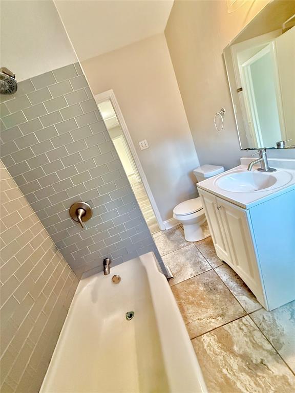 428 East Elm Street Denison, TX 75021 - Photo 15 of 18 a bathroom with a sink a toilet and a mirror