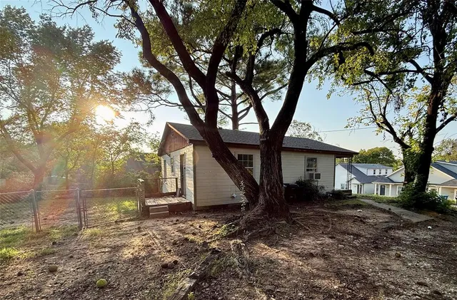 a backyard of a house with lots of trees