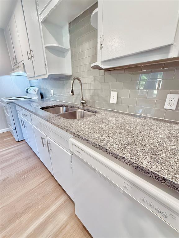 428 East Elm Street Denison, TX 75021 - Photo 7 of 18 a kitchen with sink stove and cabinets