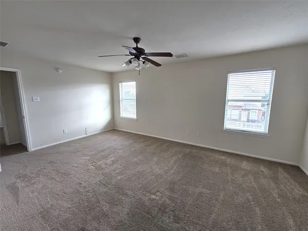 a view of a big room with a ceiling fan