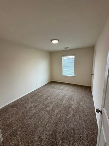 an empty room with a empty space and window