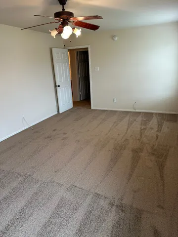 a view of a livingroom with a chandelier fan