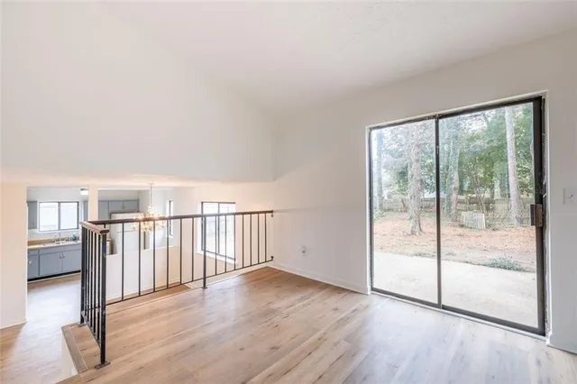 a view of a room with wooden floor and windows