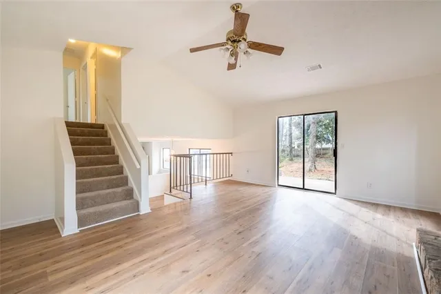 wooden floor in an empty room with a window