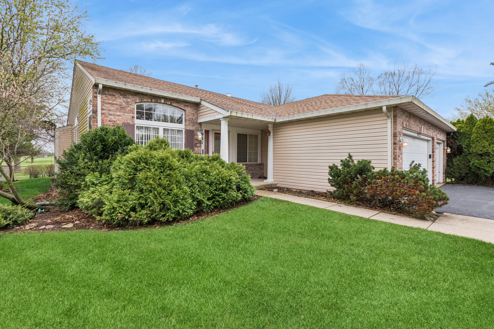 a view of an house with backyard space and garden