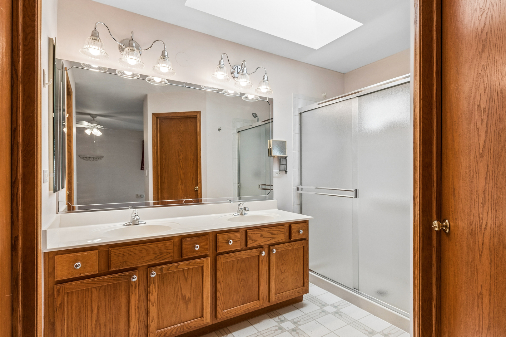 1921 Baldwin Way Bolingbrook, IL 60490 - Photo 11 of 20 a bathroom with a double vanity sink and a mirror