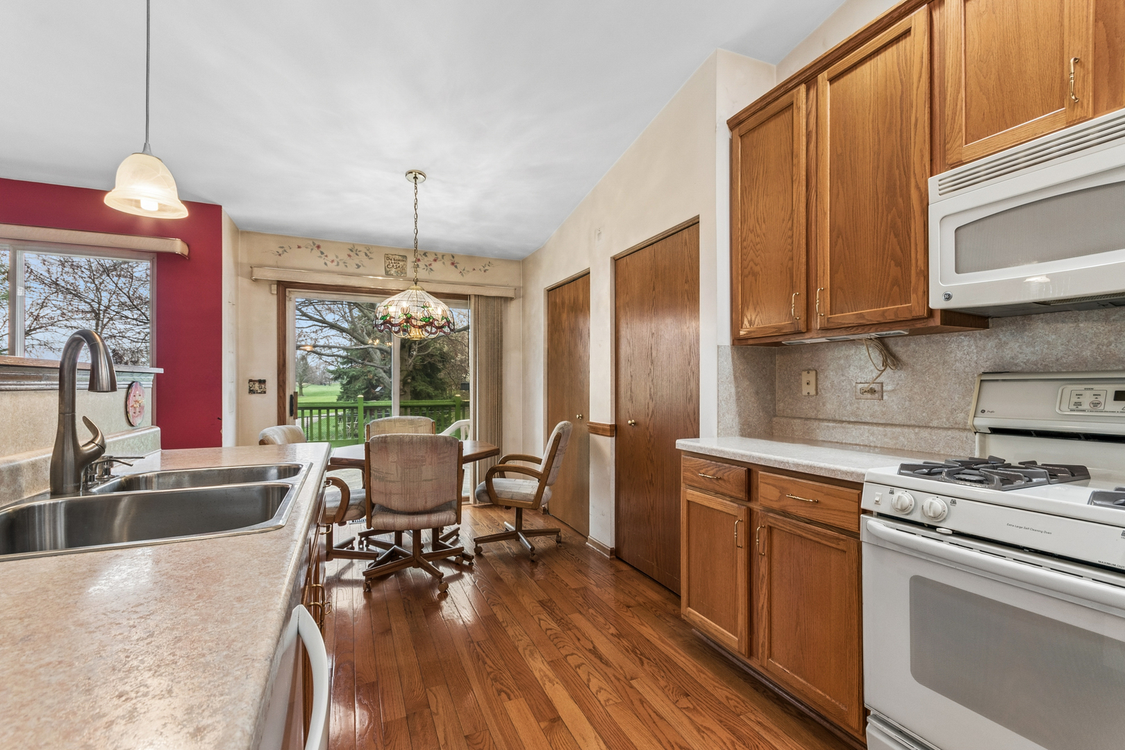 1921 Baldwin Way Bolingbrook, IL 60490 - Photo 13 of 20 a kitchen with a sink stove and wooden floor