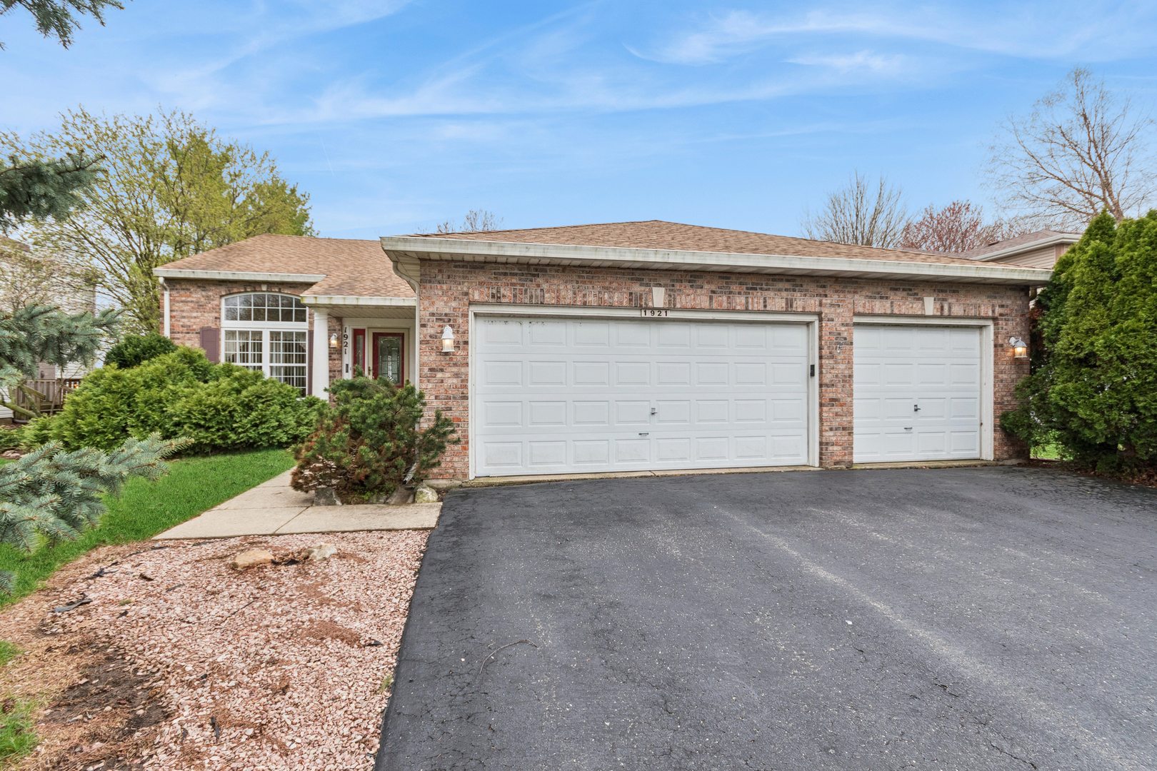 1921 Baldwin Way Bolingbrook, IL 60490 - Photo 2 of 20 a front view of a house with a yard and garage