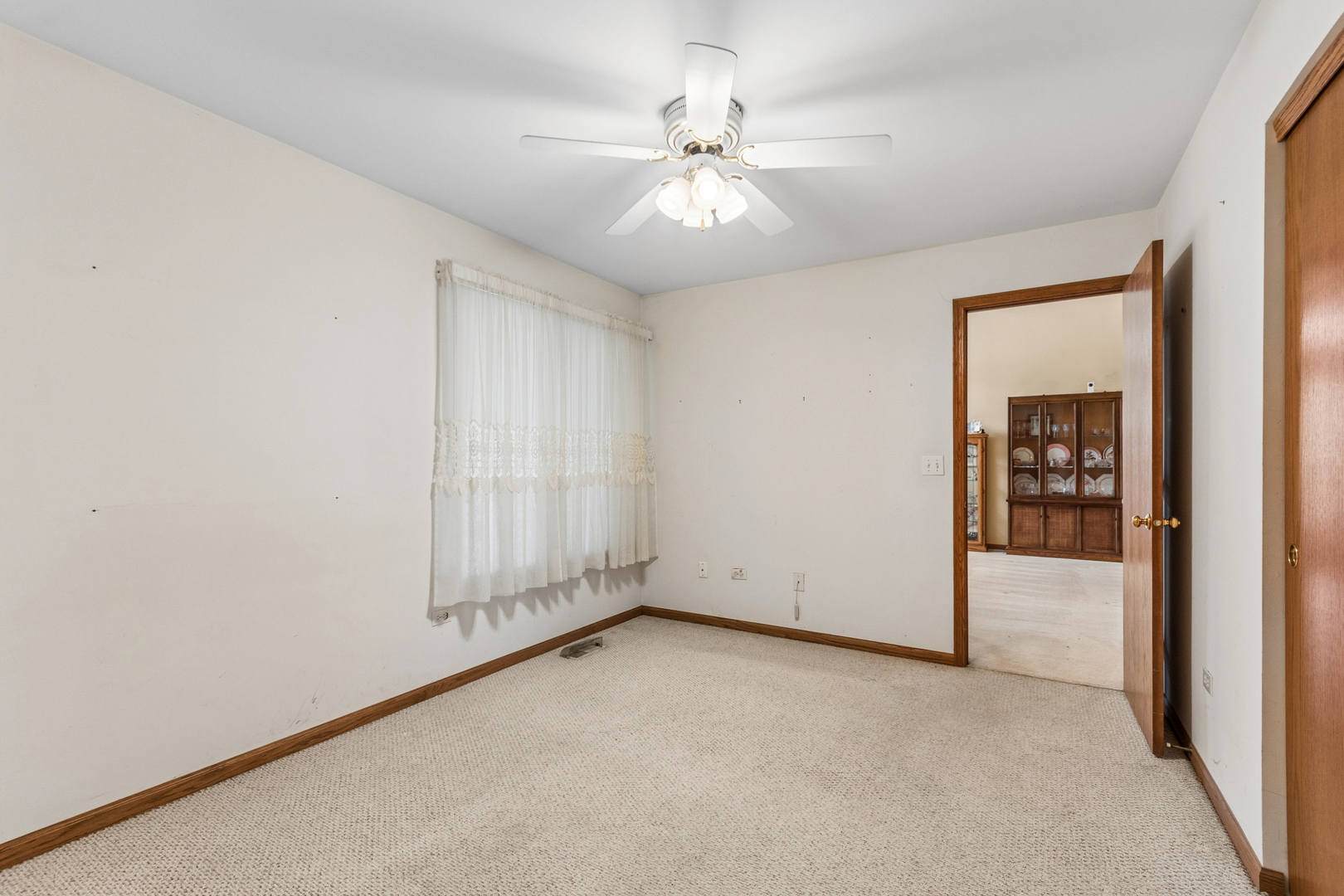 1921 Baldwin Way Bolingbrook, IL 60490 - Photo 5 of 20 an empty room with chandelier fan and windows