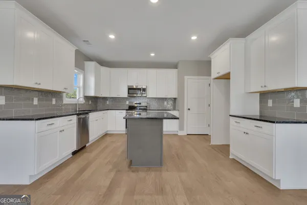 a view of an empty room with a fireplace and a window