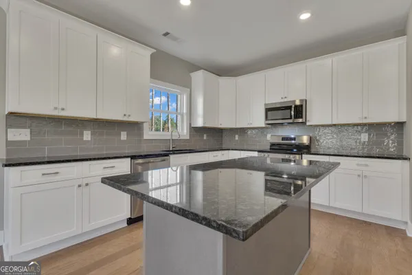 a view of an empty room with a window and fireplace
