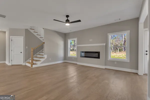 a kitchen with granite countertop white cabinets and a sink