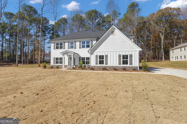 a front view of a house with a yard