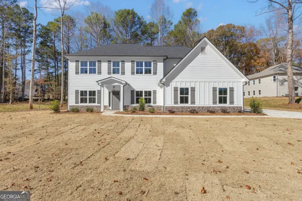a front view of a house with a yard